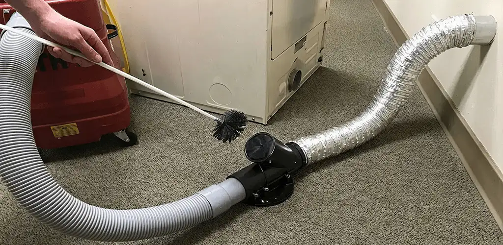 Dryer vent cleaning service removing lint from a dryer duct connection in Naperville, IL