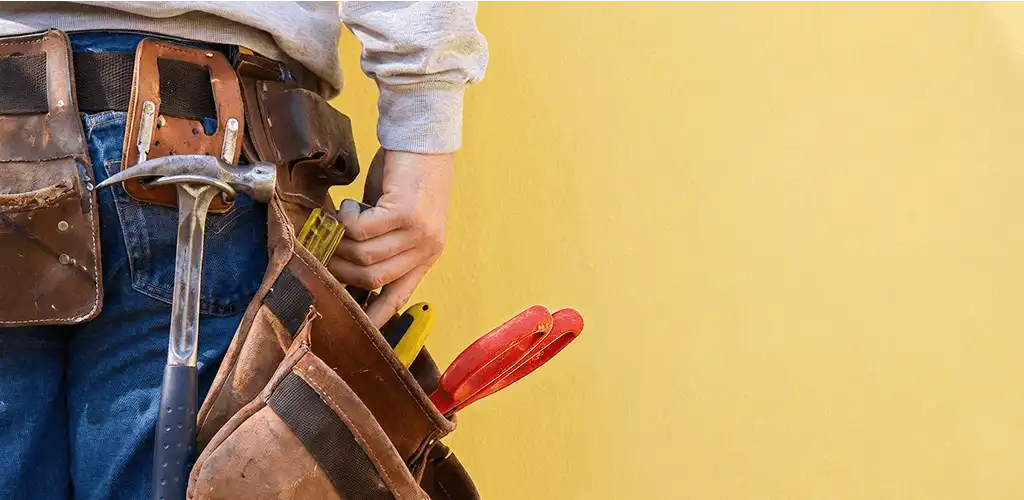 Handyman with tool belt ready for home repairs and maintenance in Naperville, IL