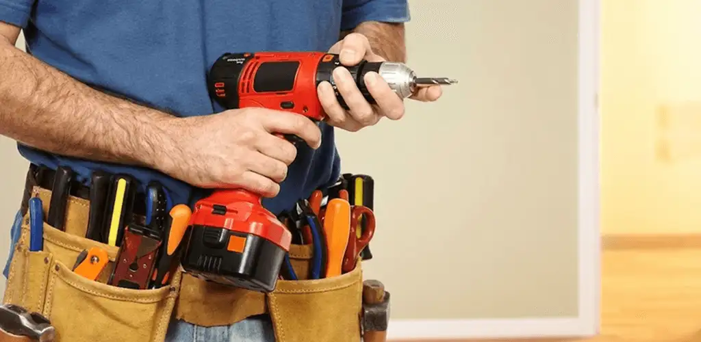 Handyman holding a power drill for home repairs and installations in Naperville, IL