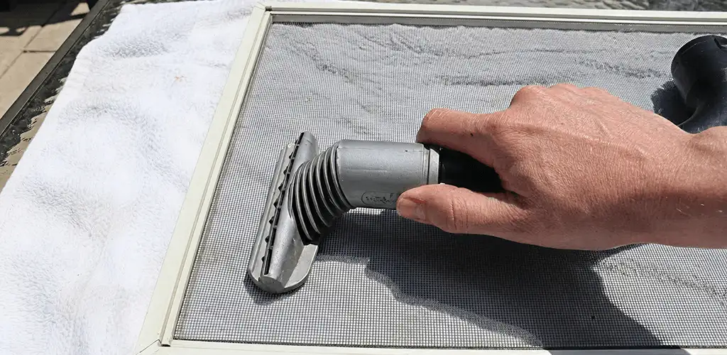 Window screen repair cleaning and fixing a damaged screen mesh in Naperville, IL
